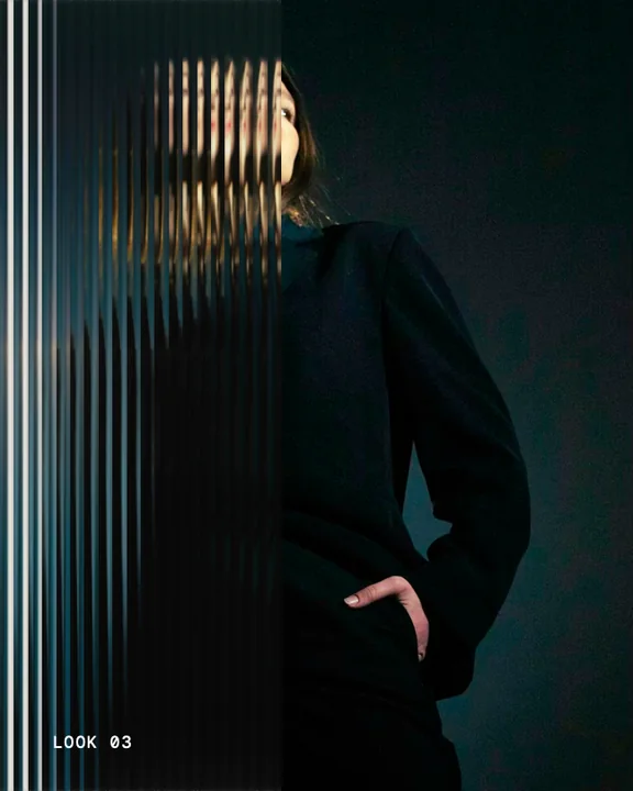A figure in a dark coat behind a pane of reeded glass